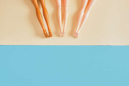 Creative minimal beach concept. Summer vacation layout with doll legs on paper sand, flat pool, beach top view copry spaceの写真素材