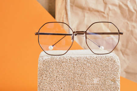 eye glasses on concrete block brown background, artist workshop concept copy spaceの写真素材