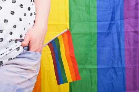 Rainbow LGBT flag in the back pocket of jeans, concept of gender equality. Lesbian and gay...