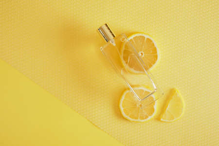 citrus scent, perfume with lemon scent concept, lemon wedges and a bottle of perfume copy spaceの写真素材