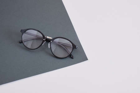 trendy stylish eye glasses on a gray background, geometry background copy space, top view optics conceptの写真素材