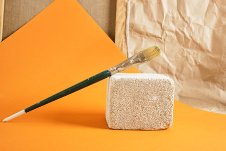 paint brush on concrete podium, art workshop concept copy space
