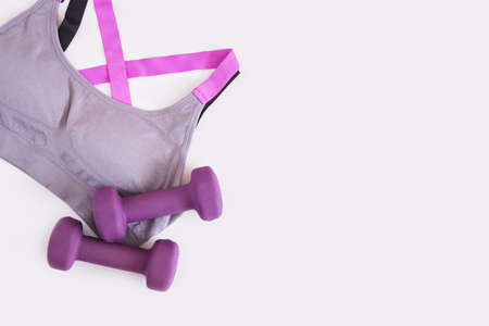 sports bra and two dumbbells on a gray background copy spaceの写真素材