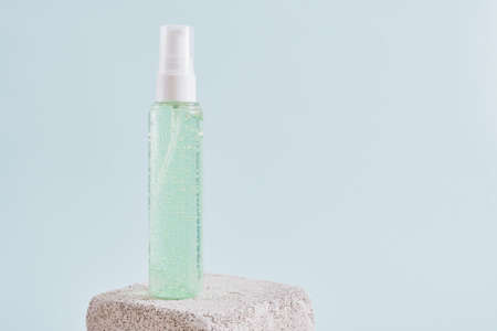 two mock up blank plastic bottle withgreen gel on a concrete podium on a light blue background, cosmetic bottles, a bottle with gel and perfumeの写真素材