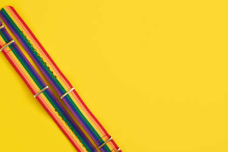 two bracelets with lgbt colors on yellow background copy space top view close up, pride conceptの写真素材