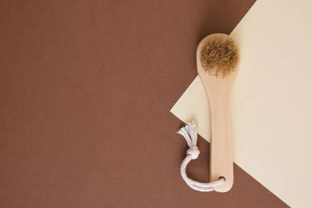wooden brush with natural bristles for dry face massage on brown and beige background eco friendly lifestyleの写真素材