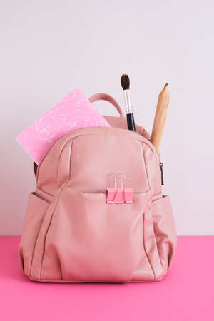 leather pink shoulder backpack on gray background, school ladies backpack with big whale, big pencil and notebook, back to school conceptの写真素材