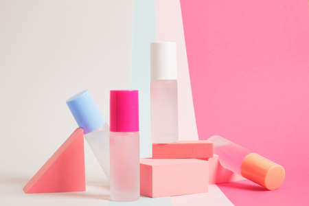 several bottles of perfume of different colors on a bright colorful background, mock up perfume...
