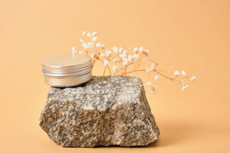 alluminum cream jar on stone with dry flowers on beige background eco friendly product concept, organic cosmeticの写真素材