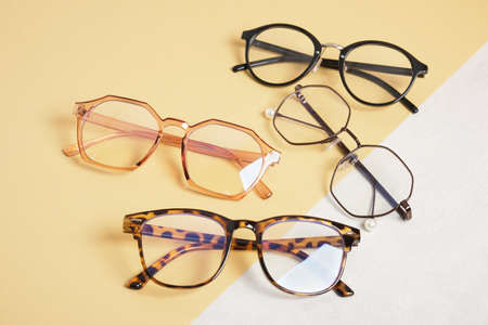 several trendy stylish eyes glasses on beige and gray background copy space top viewの写真素材