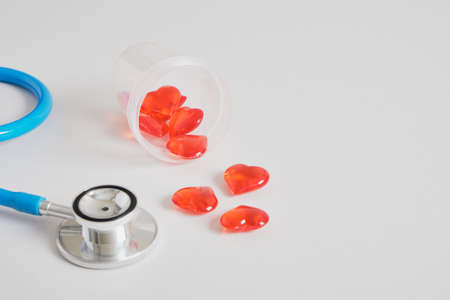hearts in a jar for tests and a medical stethoscope on a gray background copy space, sperm and egg donation, artificial insemination and surrogacy conceptの写真素材