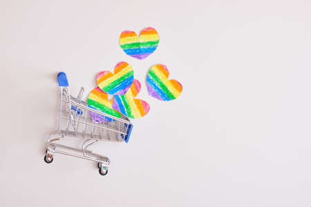 shopping cart and paper drawn cut out hearts rainbow color on gray background, pride conceptの写真素材