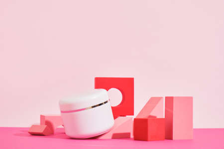 white mockup jar of cream on a pink podium on a pink background, bottles for perfume or serum Cosmetic mock up jar. Branding identity mockup concept.の写真素材