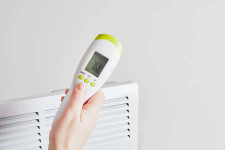 electric infrared thermometer for measuring surface temperature and air on the background of...