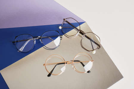 fashion trendy eyes glasses for correcting vision on a creative background, colorful shiny cardboard...