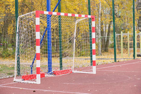 Outdoor sports ground. empty soccer goal Active healthy games. Beautiful autumn landscape background