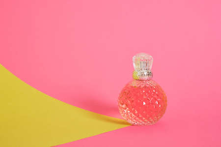 cristal glass perfume bottle on pink background copy spaceの写真素材