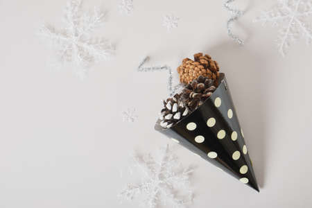 paper homemade party hat and christmas decor on a gray background, postcard copy space for the new year, eco friendly holiday conceptの写真素材