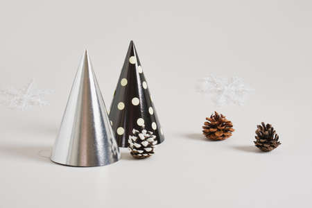 paper homemade party hat and christmas decor on a gray background, postcard copy space for the new year, eco friendly holiday conceptの写真素材