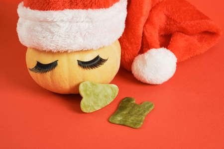 gau sha scrapers made of natural jadeite and a cute pumpkin with false eyelashes and a santa hat on...