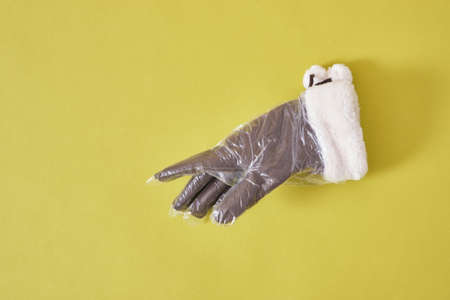 Products made of recycled plastic concept, gloves with fur in a disposable polyethylene glove, green...