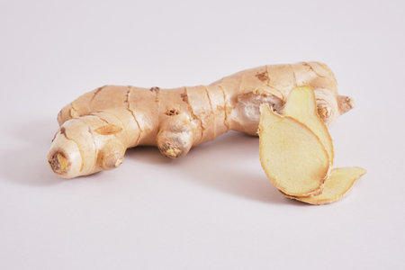 fresh ginger on grey background copy space, ginger root and slicesの写真素材