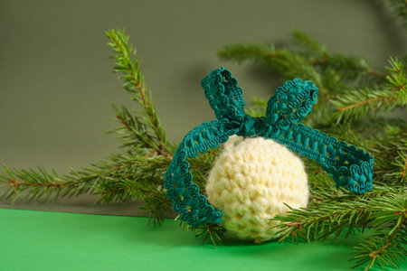 handmade. knitted balls for the Christmas tree, crocheted Christmas toys, fir branches. green...