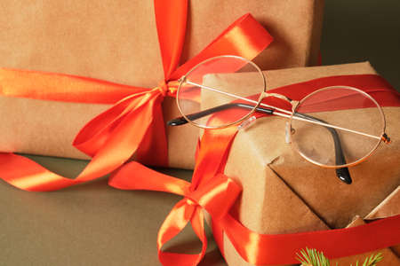 beatiful trendy eye glasses on gift box with red ribbon, christmas mood, Snata eyeglasses styleの写真素材