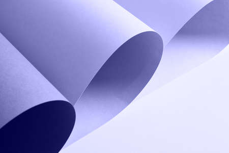 very peri color trend 2022 sheets among minimalism, pastel colors, abstraction paper background, rolled sheets of paper copy space mock upの写真素材