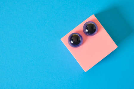 funny friendly face with eyes from the children's game constructor on a blue background copy space...