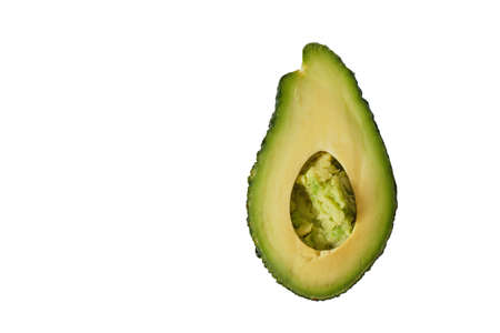 fresh whole and sliced avodcado fruit on light background isolated creative minimalismの写真素材