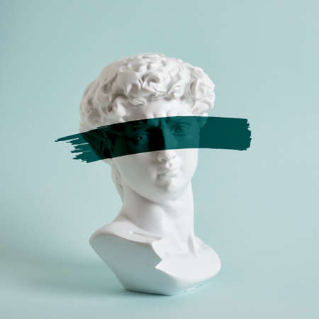 bust of david replica on a light blue background copy space, a copy of the work of michelangelo, art with antique sculptureの写真素材