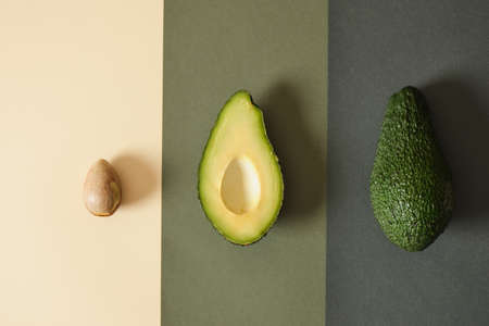 fresh whole and sliced avodcado fruit on green light background top view helthy food concept