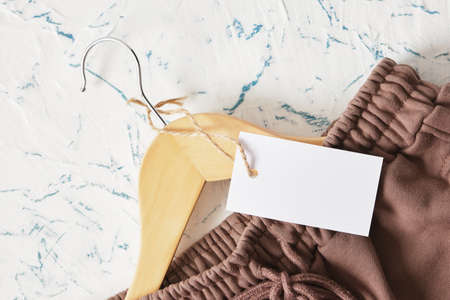 wooden clothes hanger, pants and blank tag Slow fashion, circular economy, eco friendly sustainable...