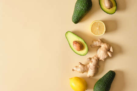 sliced avocado, lemon and ginger on beige background top view copy spaceの写真素材