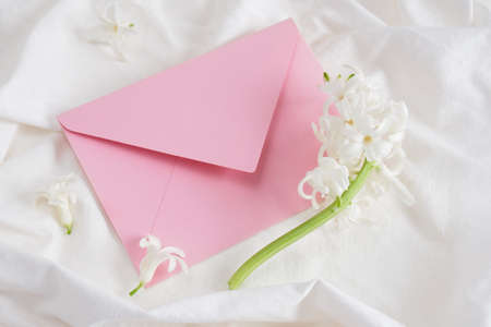 white hyacinth and envelope pink on white bedn, birthday card, flower for anyone, congratulations on March 8 or February 14の写真素材
