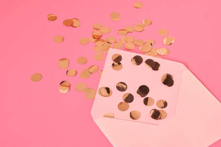 golden confetti pink paper letterhead envelope on pink background, congratulation concept, valentine's day postcard, mother's day, 8th march giftの写真素材