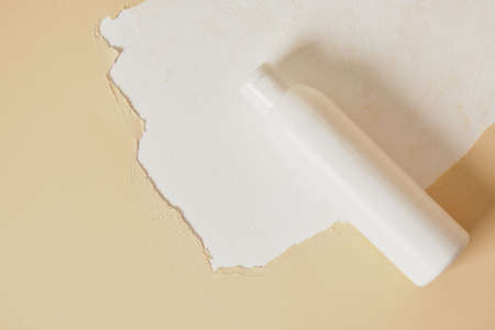 moe up blank bottle with cosmetics on creative background from torn paper and textured surface, cosmetics for body skin care presentation, mock up without labelsの写真素材