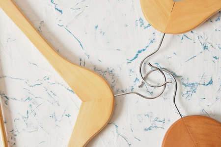 wooden clothes hangers and coat hangers on light background.の写真素材