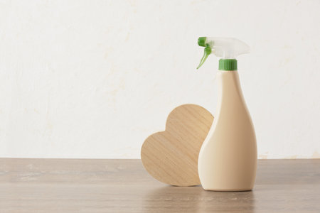 eco cleaning concept, spray bottle and wooden heart on table on light background copy space mock upの写真素材