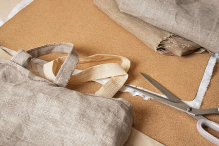 cork bag sewing process, natural materials for eco-friendly accessories, cotton and cork leather shopper, leggings and a sewing machine on blanks for tailoringの写真素材