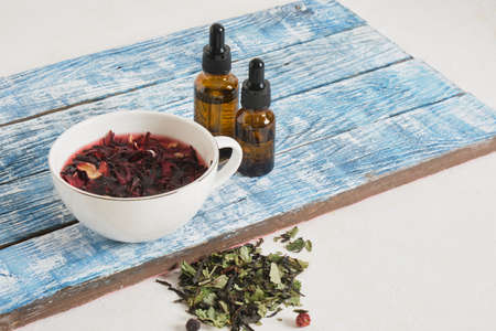 hibiscus brewed tea in a cup and two dropper bottles with pipettes, drink additives, anti-stress drink, adaptogens for calmnessの写真素材