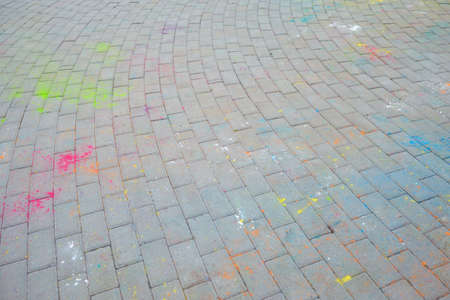the Indian festival holi, Hindi, the remains of color powder on asphalt, paint stains on the road