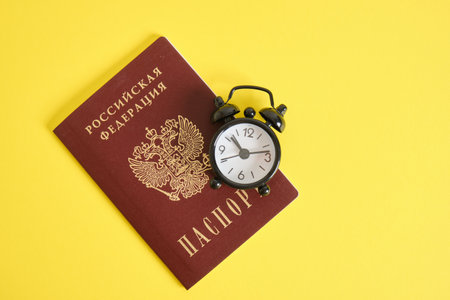passport of a citizen of Russia and an alarm clock, countdown, change of events, travel and education conceptの写真素材