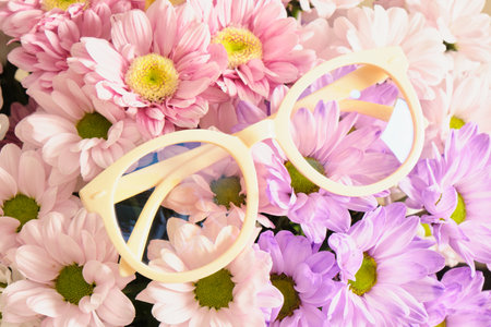 trendy beige plastic eye glasses and flowers, fashion eyewear conccept, creative shoecaseの写真素材
