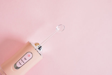 Dental Water Teeth Cleaner Water Flossing Oral Irrigator on pink backgroundの写真素材