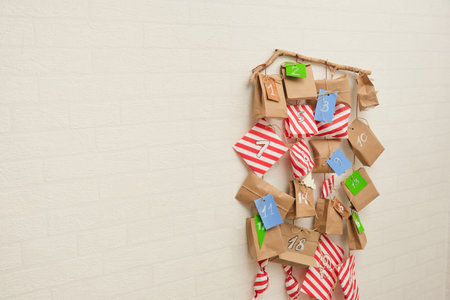 homemade advent calendar hanging on the wall, traditional surprises every day until Christmas,...