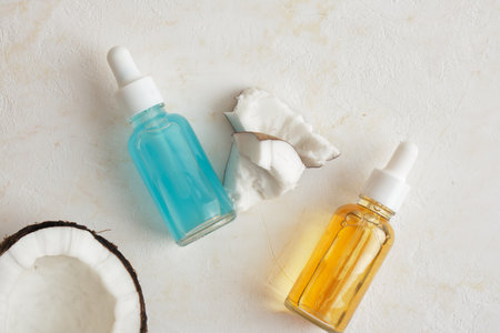 Natural organic coconut oil or serum in glass dropper bottles, natural cosmetic with coconut extractの写真素材