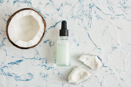 Natural organic coconut oil or serum in amber glass dropper bottle, natural cosmetic with coconut extractの写真素材