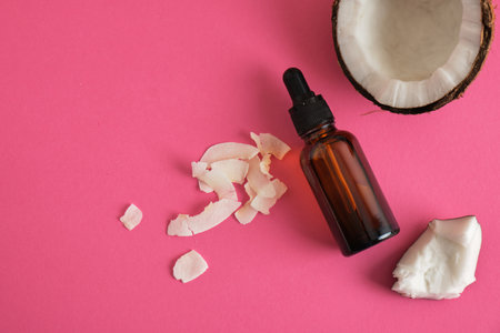 Natural organic coconut oil or serum in amber glass dropper bottle, natural cosmetic with coconut extractの写真素材